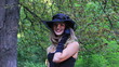 girl in a hat speaks by phone and smiles