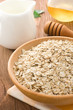 Bowl of oat and milk on wood