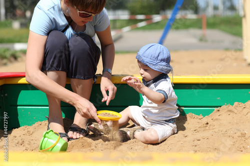 Photo: Mother and her son sifted sand Mother and her son sifted sand