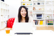 a young asian woman using laptop computer
