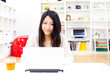 a young asian woman using laptop computer