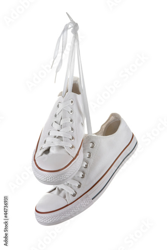 Photo: Pair of new white sneakers isolated on white Pair of new white sneakers isolated on white