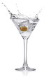 Photo: Splash from olive in a glass of cocktail. Splash from olive in a glass of cocktail.
