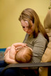 mother is breast feeding a newborn baby