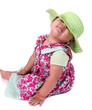 Adorable baby girl in pink flowery dress, on white background