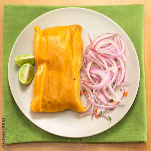 Photo: Peruvian tamale made of corn and chicken with salsa criolla Peruvian tamale made of corn and chicken with salsa criolla
