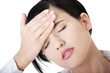 Businesswoman with a headache holding head