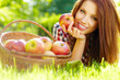 Beautiful woman in the garden with apples