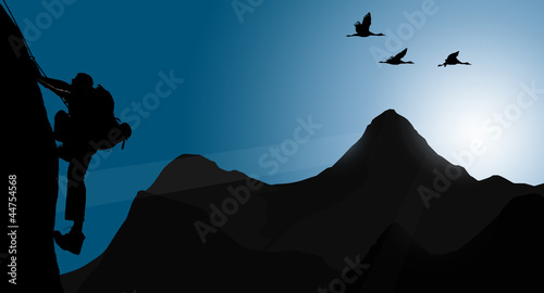 Photo: Silhouette of climbing young adult at the top of summit Silhouette of climbing young adult at the top of summit
