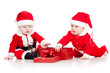 two funny small kids in Santa Claus clothes with gift box