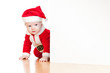 small Santa claus child looking from behind the placard