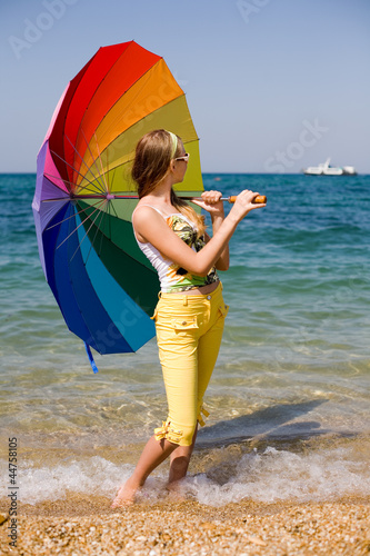 Photo: Teenage girl carrying iridiscent umbrella Teenage girl carrying iridiscent umbrella