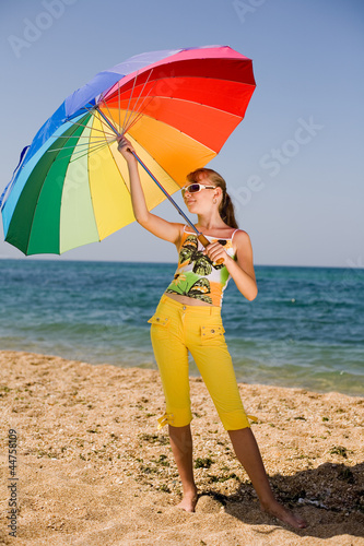 Photo: Teenage girl carrying iridescent umbrella Teenage girl carrying iridescent umbrella