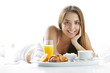 Photo: Smiling woman having breakfast Smiling woman having breakfast