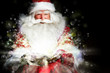 Santa sitting at the Christmas room and looking into the sack