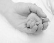 newborn baby hand on a female hand