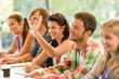 Photo: High-school student raising her hand in class High-school student raising her hand in class