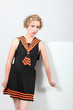 Doubtful woman wearing a fashionable dress