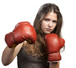 Attractive young woman wearing boxing gloves