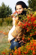 Portrait of beautiful pregnant woman walking in autumn park