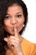 Woman holding her finger to her lips
