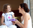 Little beautiful pretty girl giving a gift to her happy mother -