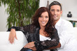 Couple embracing on white sofa
