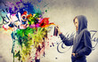 Blonde girl making a very colorful graffiti