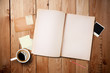 Workspace with coffee cup, instant photos and notebook