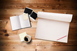 Workspace with coffee cup, instant photos, note paper and notebo