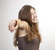 Young cute smiling girl pointing on you