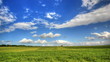 Timelapse clouds over the green field.