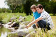 Fashing and Son Playing Near Lake