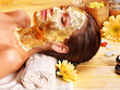 Woman getting  facial mask .