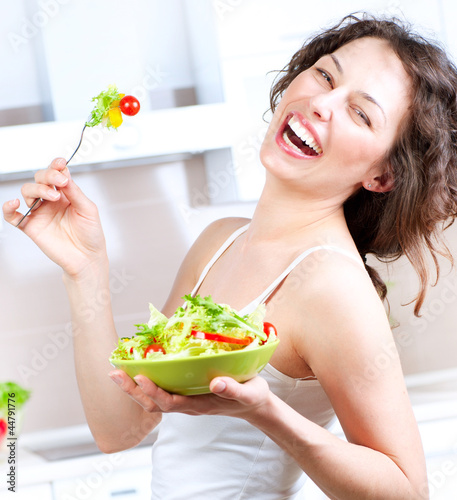 Photo: Diet. Healthy Young Woman Eating Vegetable Salad Diet. Healthy Young Woman Eating Vegetable Salad