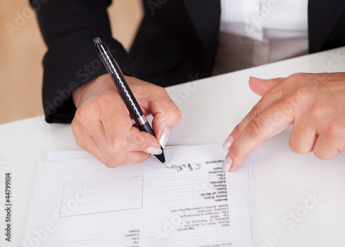 Photo: Signing a document Signing a document