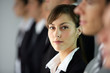 Young woman standing in line with co-workers