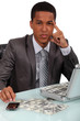 Young businessman with a briefcase full of money