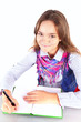 Photo: smiling girl doing homework isolated over white backgorund smiling girl doing homework isolated over white backgorund