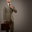 Businessman with a briefcase isolated on grey