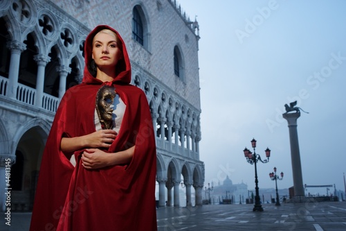 Photo: Beautiful woman in red cloak against Dodge's Palace Beautiful woman in red cloak against Dodge's Palace