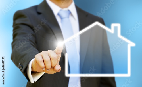 Photo: Businessman drawing his house with his finger Businessman drawing his house with his finger