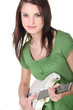 Young woman playing the electric guitar
