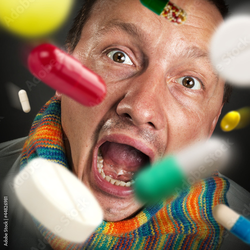 Photo: Pills falling into open mouth Pills falling into open mouth