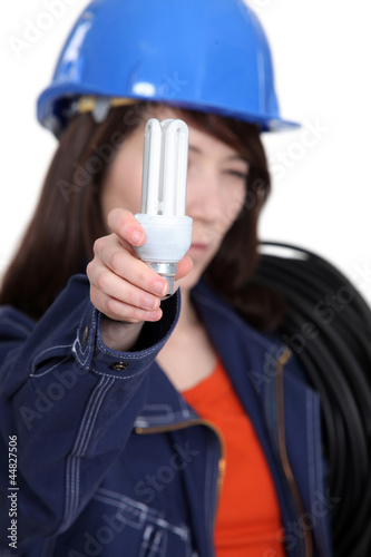 Photo: Electrician holding a compact fluorescent lamp Electrician holding a compact fluorescent lamp