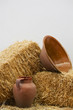 clay utensils and straw haystack