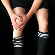 Soccer Male Player Holding Inj...