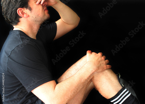 Photo: Soccer Player Holding Injured Knee Soccer Player Holding Injured Knee