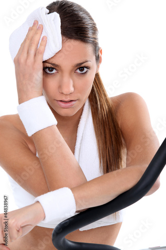 Photo: Woman in the gym using cycle machine Woman in the gym using cycle machine