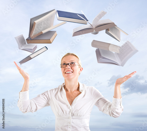 Photo: Woman with flying books Woman with flying books
